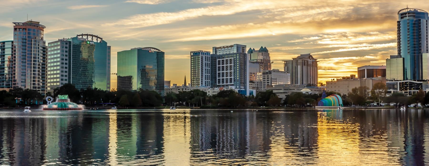 a city skyline with a body of water in front of it